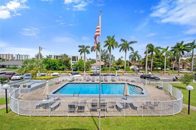 view of pool with a yard