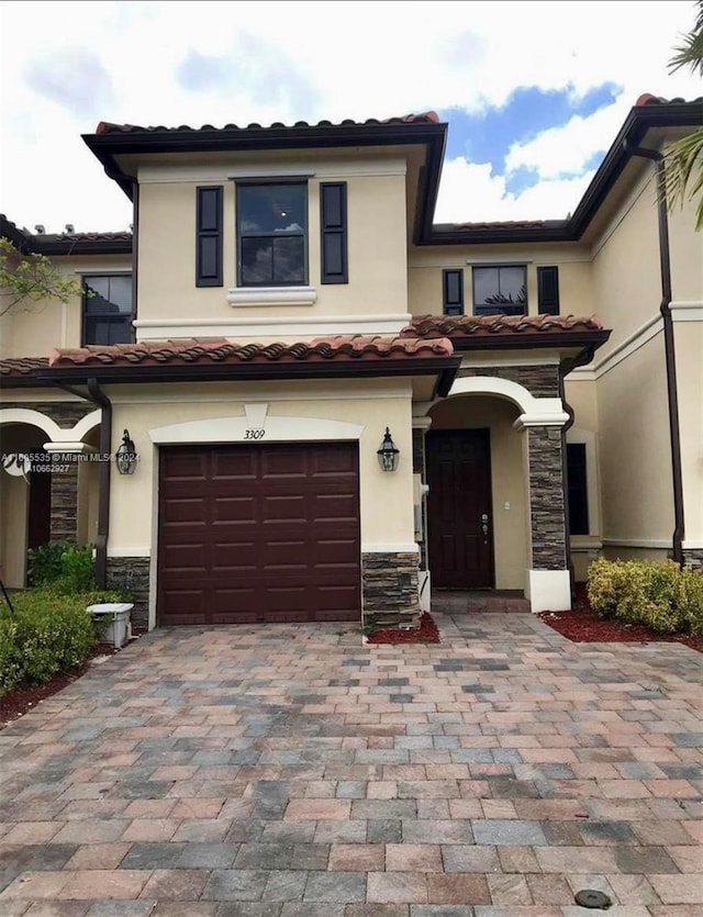 mediterranean / spanish-style house with a garage