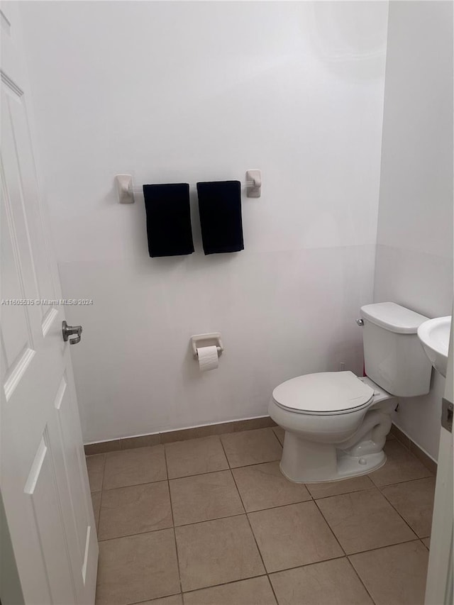 bathroom featuring tile patterned flooring and toilet