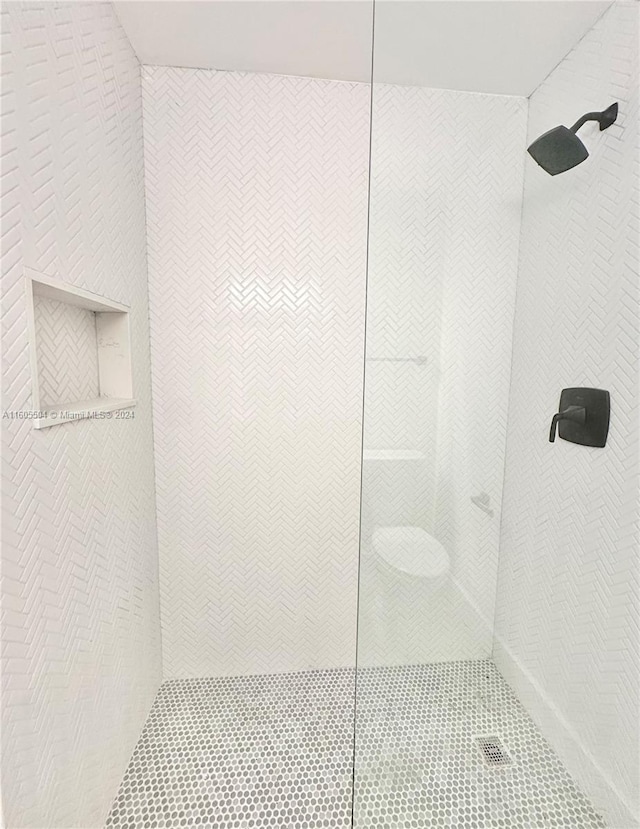 bathroom with tiled shower