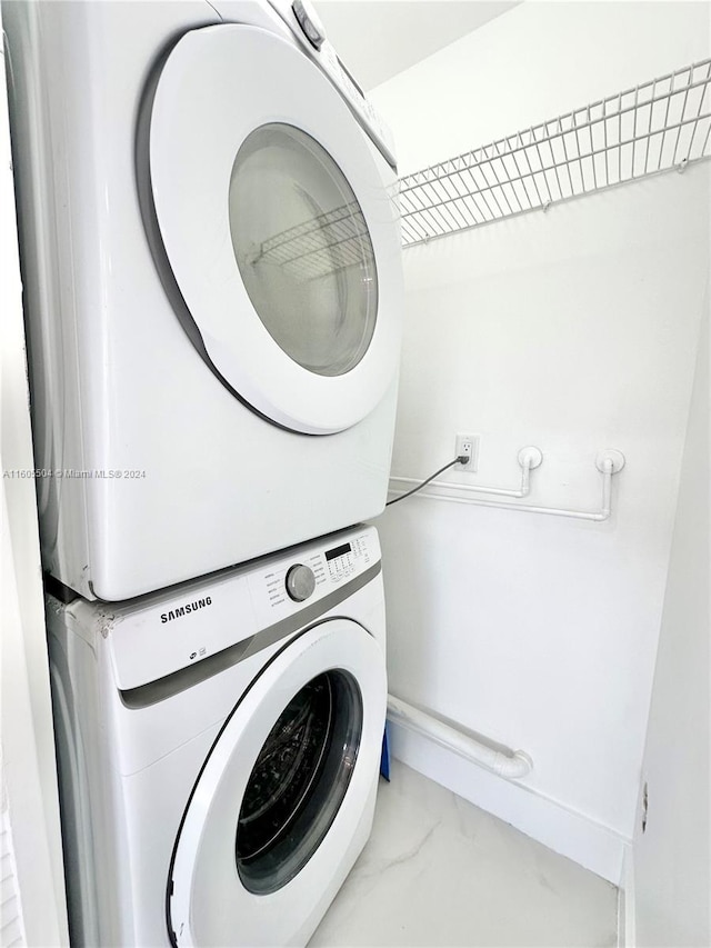 laundry area with stacked washer and dryer