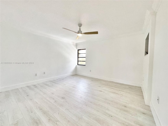 unfurnished room featuring crown molding, ceiling fan, a textured ceiling, and light wood-type flooring