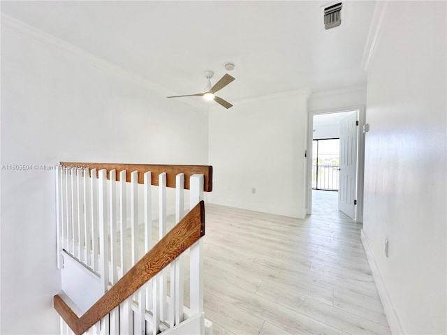 hall featuring light wood-type flooring and crown molding