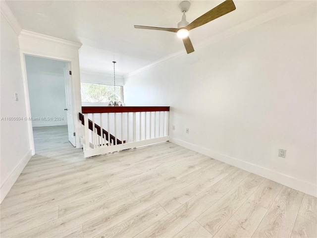 spare room featuring ceiling fan, light wood-type flooring, and ornamental molding