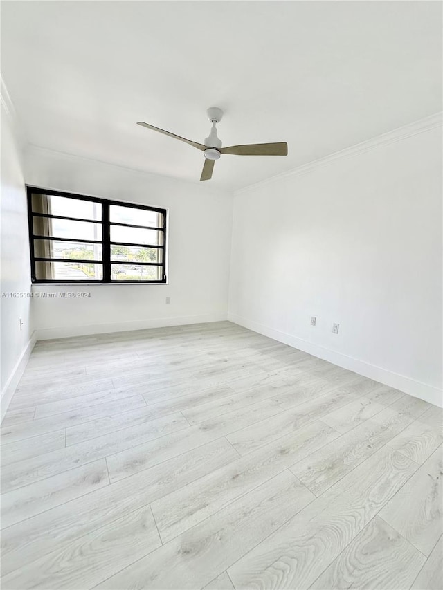 spare room with light hardwood / wood-style flooring, ceiling fan, and crown molding