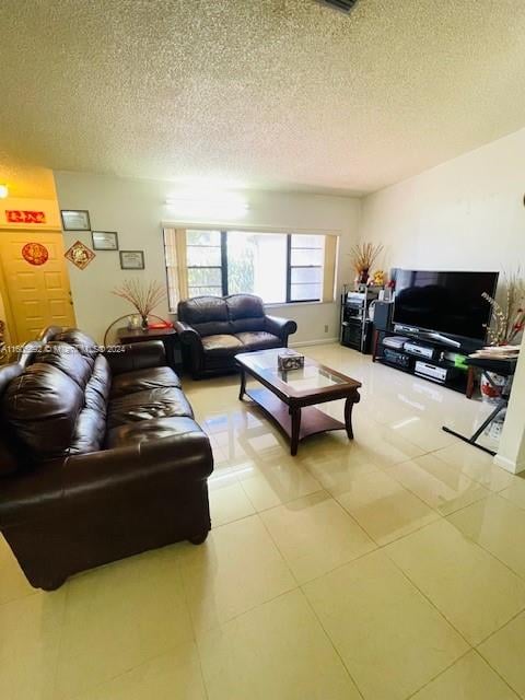 living room featuring tile floors and a textured ceiling