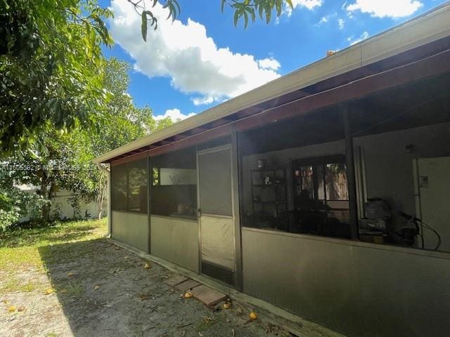 view of side of property with a sunroom