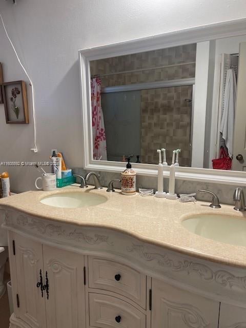 bathroom with double sink and vanity with extensive cabinet space