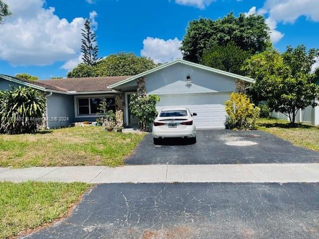 single story home featuring a garage