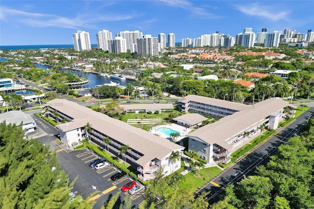 birds eye view of property with a view of city and a water view