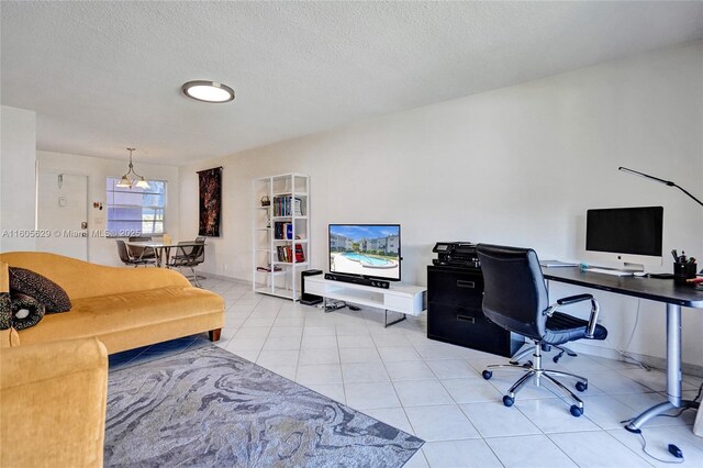 tiled home office featuring a textured ceiling and a notable chandelier