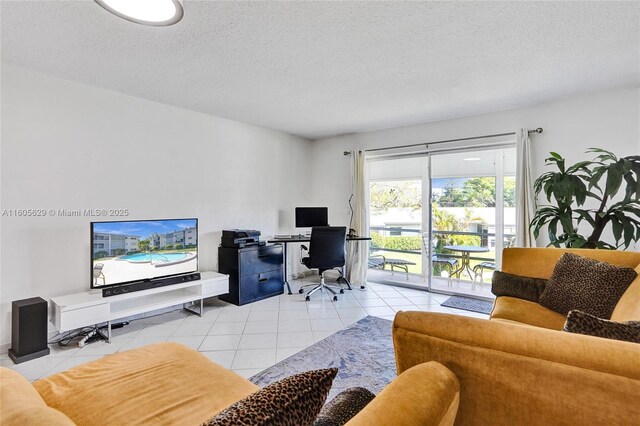 living room with a textured ceiling and light tile patterned floors