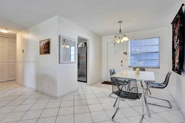 dining room with light tile patterned flooring and an inviting chandelier