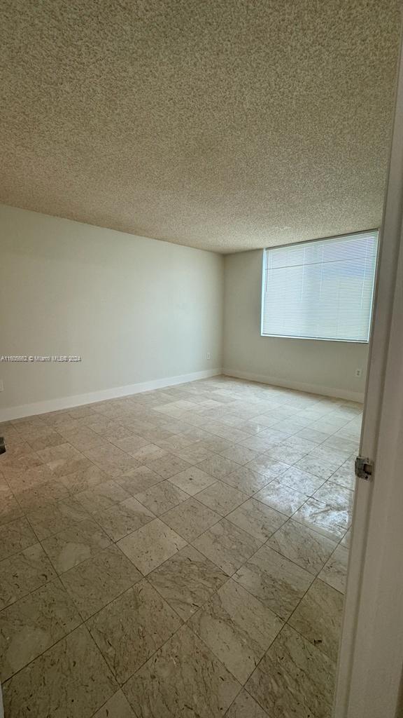 empty room with a textured ceiling