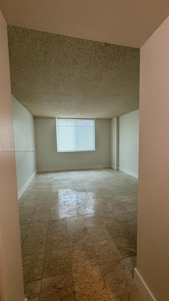 spare room with a textured ceiling