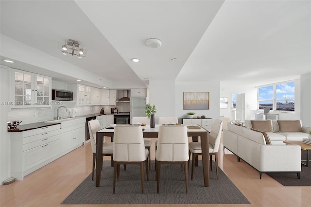 dining area with sink and light hardwood / wood-style flooring