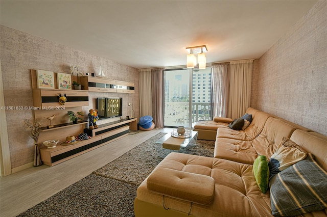 living room with hardwood / wood-style flooring and a wall of windows