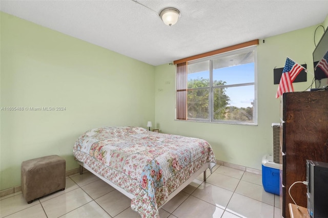 bedroom featuring tile floors and a textured ceiling