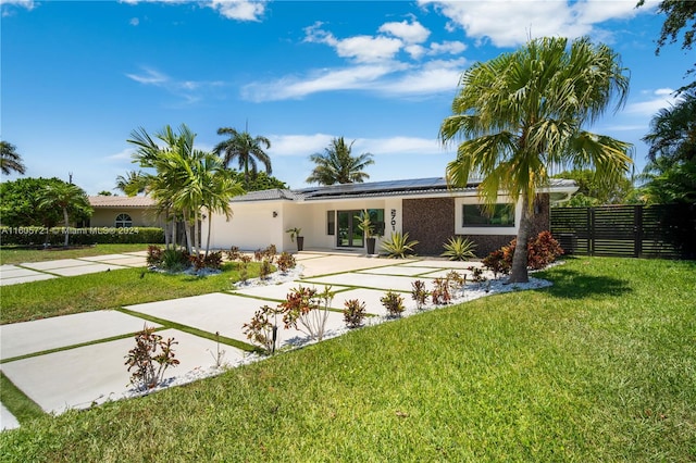 view of front of property with a patio area and a front lawn