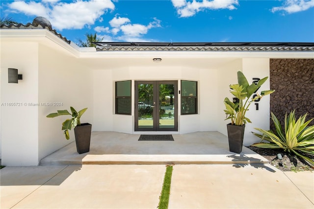 property entrance with a patio area and french doors