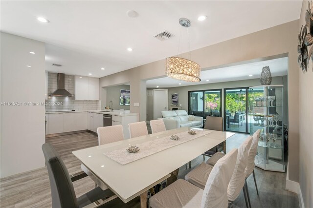 dining space with sink and light wood-type flooring