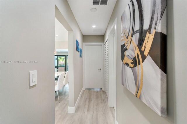 hallway with light hardwood / wood-style floors