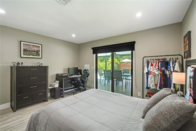 bedroom featuring access to exterior and light hardwood / wood-style flooring