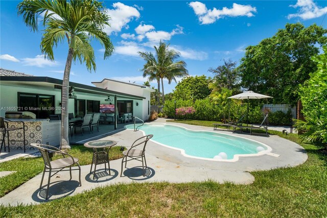 view of pool featuring a patio area and a lawn