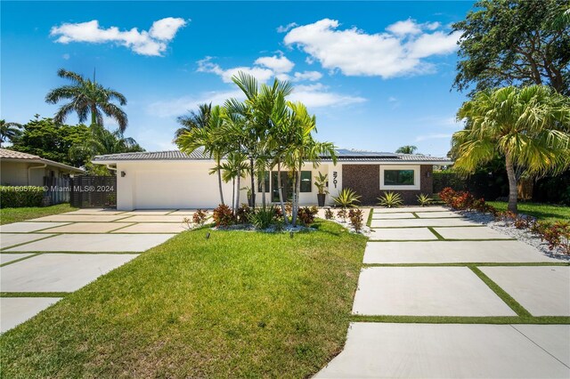 ranch-style home with a garage and a front yard