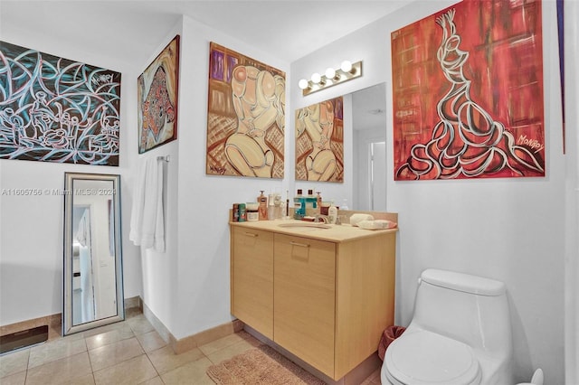 bathroom with tile patterned flooring, vanity, and toilet