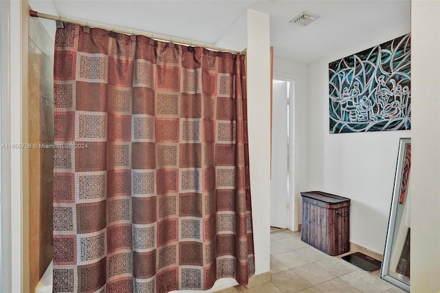 bathroom featuring curtained shower and tile patterned floors