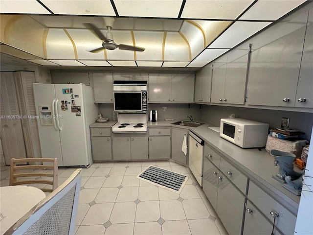 kitchen featuring ceiling fan, gray cabinets, white appliances, and sink