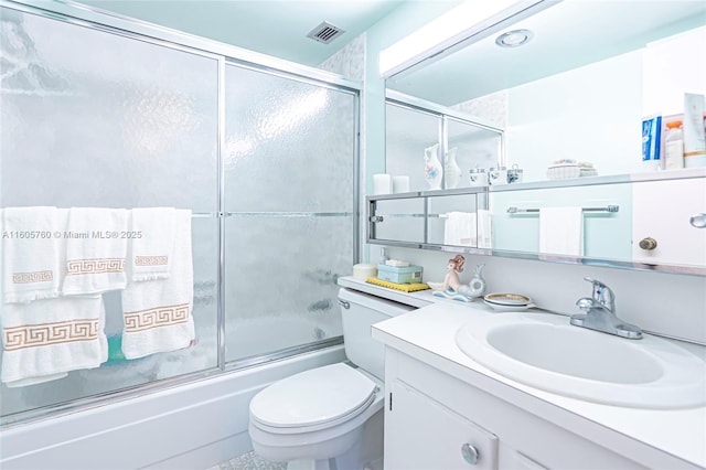 full bathroom featuring vanity, toilet, and enclosed tub / shower combo