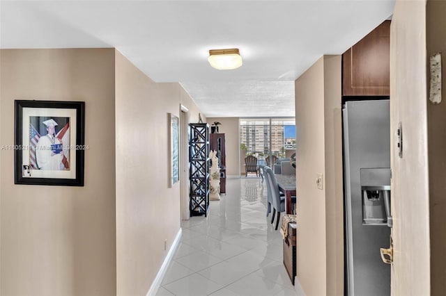 hall with light tile patterned floors