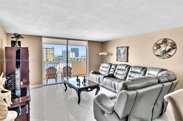 living room featuring a textured ceiling and light tile patterned floors