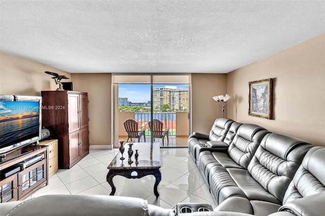 living room featuring a textured ceiling and light tile patterned floors