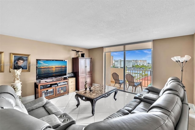 living room featuring light tile patterned floors and a textured ceiling