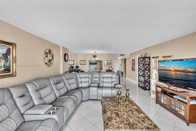 tiled living room with a chandelier and a textured ceiling