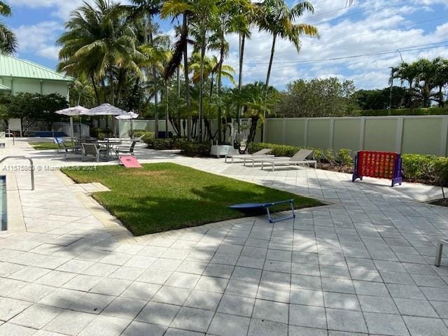 view of home's community with a yard and a patio