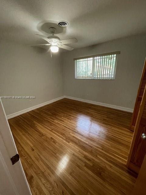 spare room featuring hardwood / wood-style floors and ceiling fan