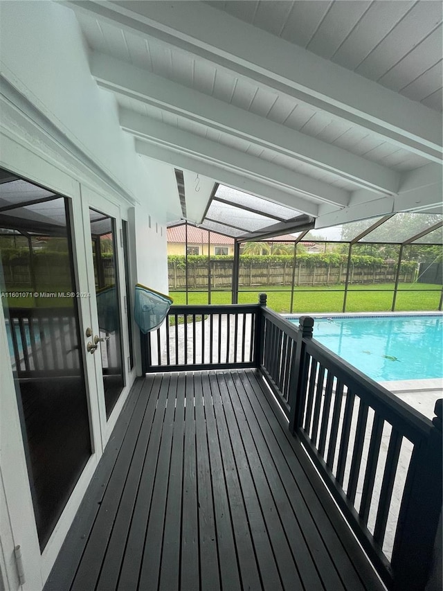 deck with french doors, a lanai, and a lawn