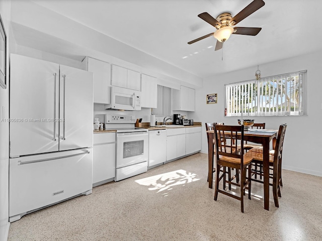 kitchen featuring white appliances, sink, ceiling fan, and white cabinetry