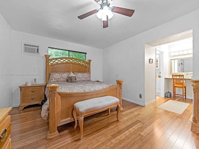 bedroom featuring ceiling fan, light wood-type flooring, and a wall unit AC