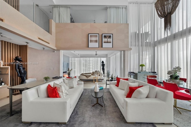 living room with a high ceiling and a wealth of natural light