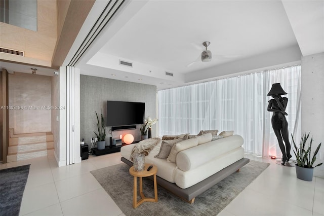 tiled living room featuring ceiling fan