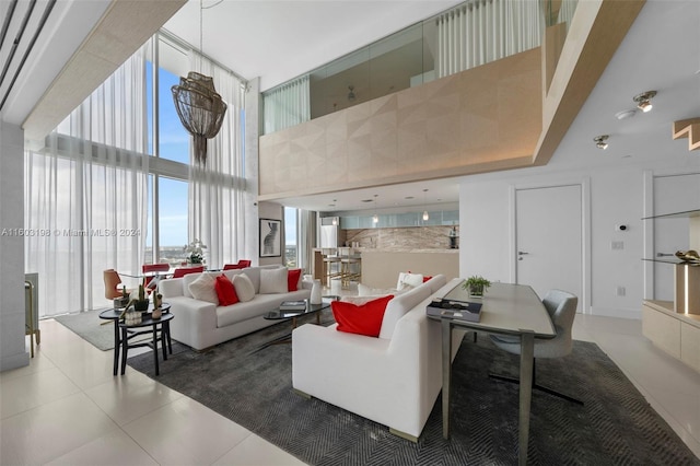 living room featuring a high ceiling and a wall of windows