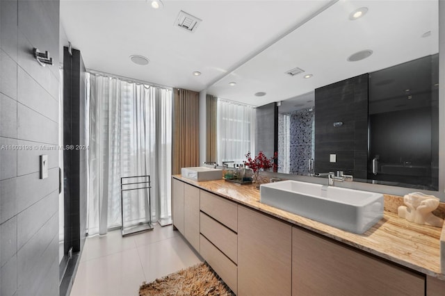 bathroom with vanity, tile patterned floors, tile walls, and a shower with shower door