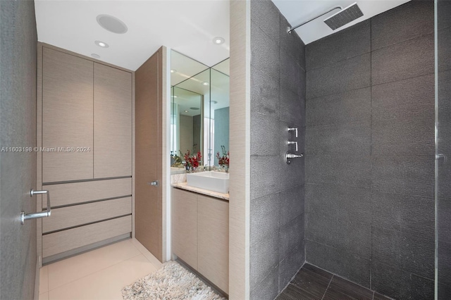 bathroom with a shower, tile patterned flooring, and tile walls