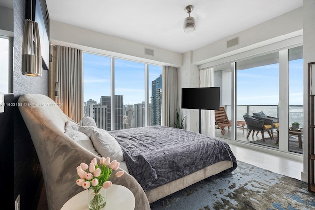 bedroom with access to exterior, tile patterned floors, and ceiling fan