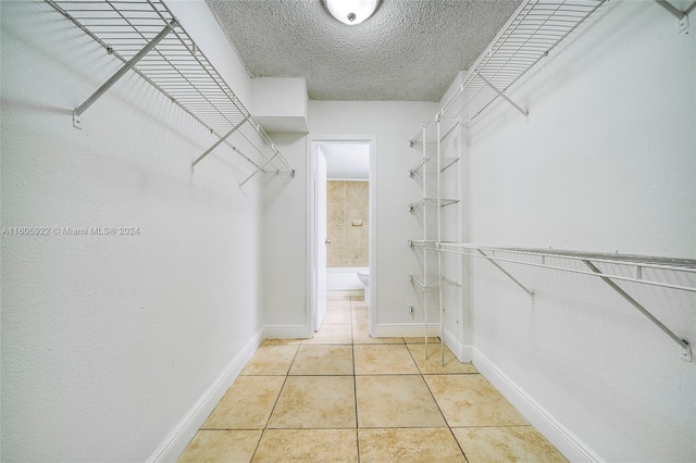 spacious closet featuring light tile floors